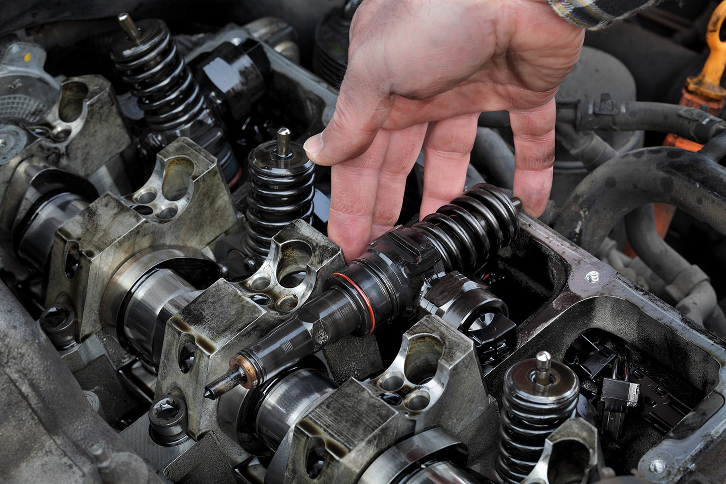 car mechanic fixing modern diesel engine