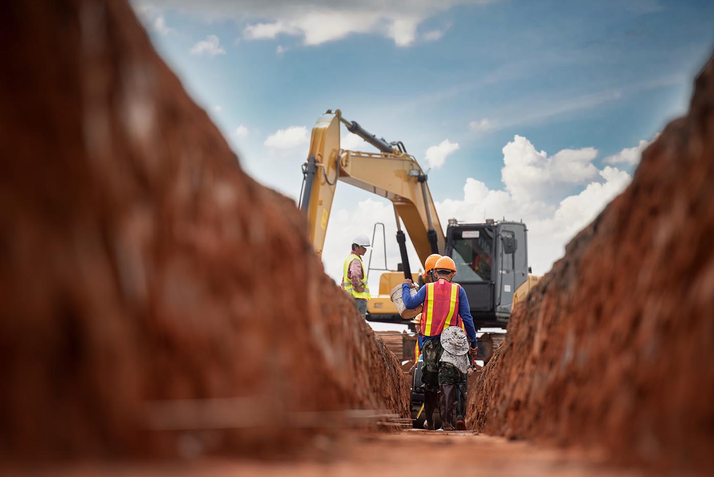 construction workers dig into earth