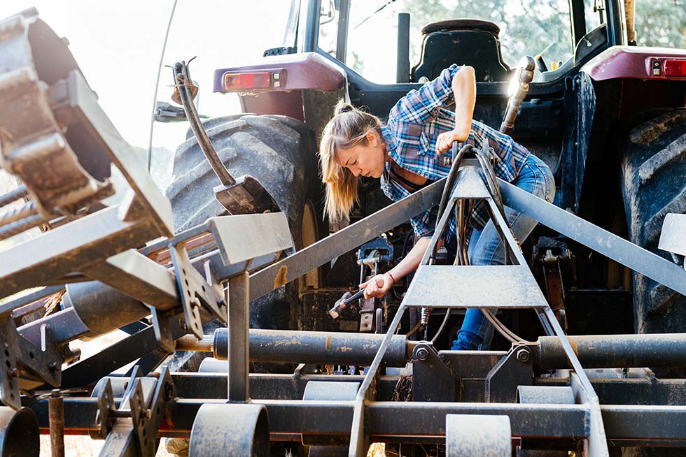 farmer repairing tractor