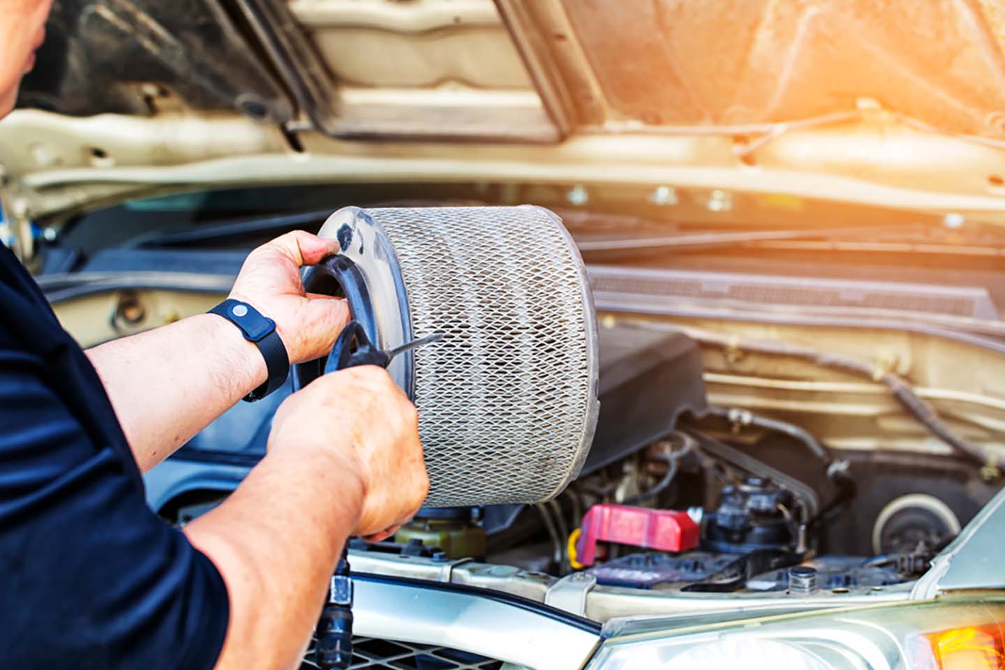 mechanic holding car filter