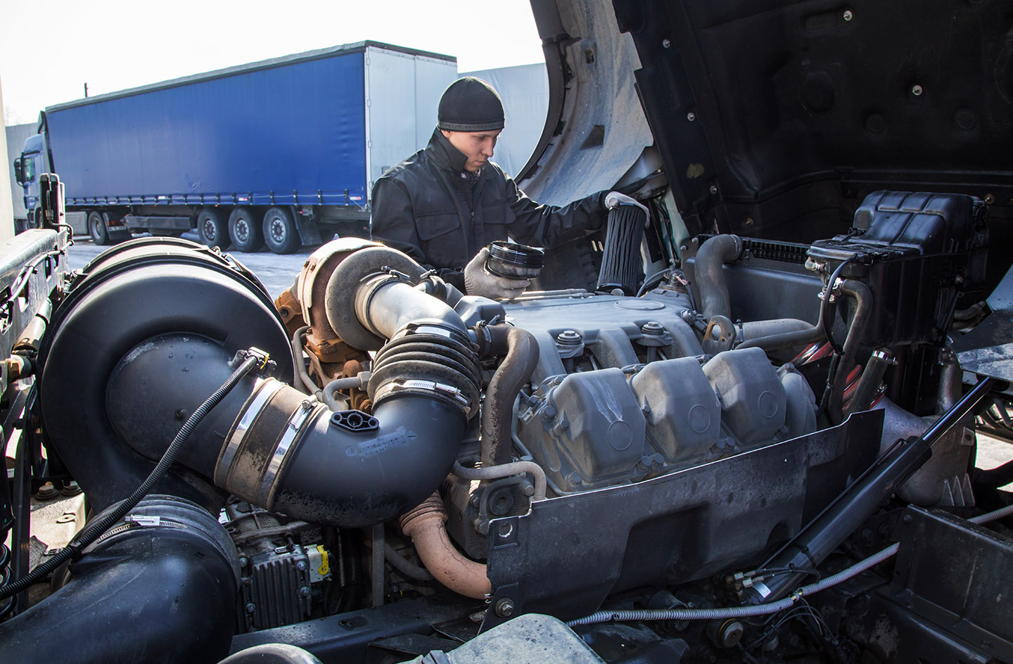 mechanic repairing a truck outside