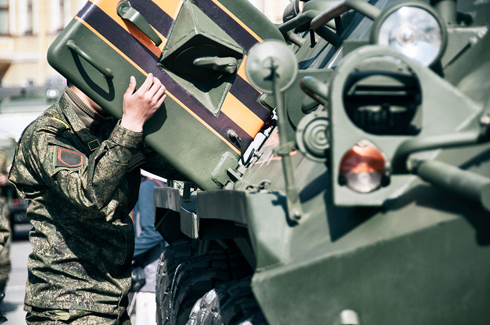 soldier maintenance on military vehicle