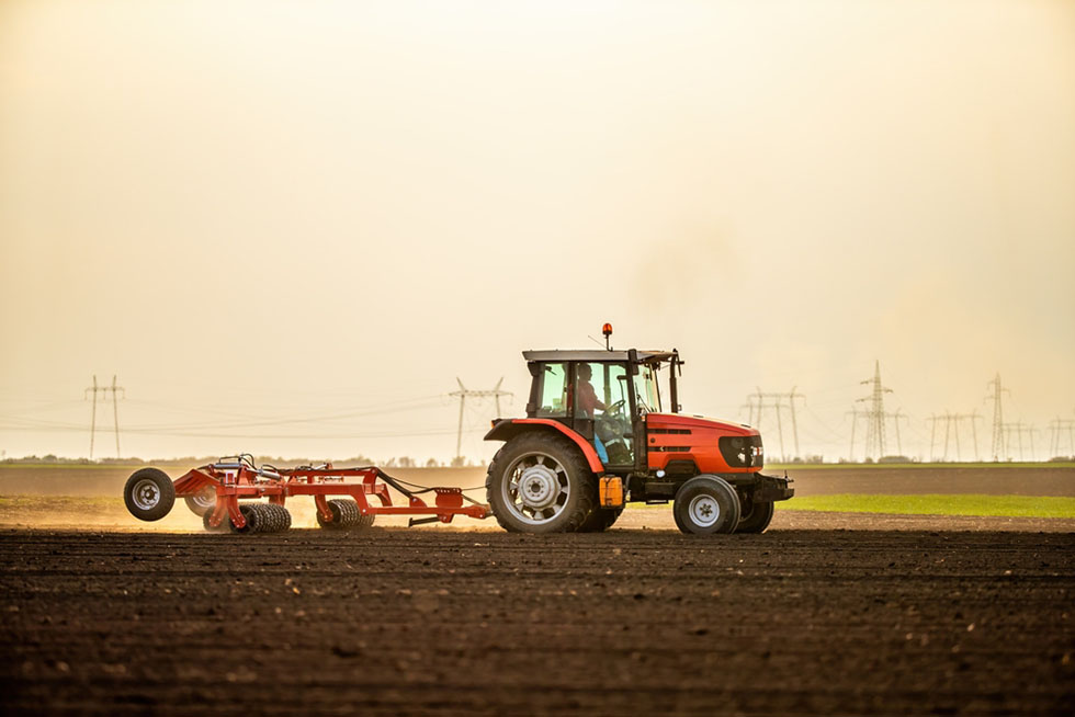 tractor sowing soil in field